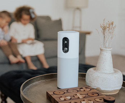  360 security camera on side table with kids in background