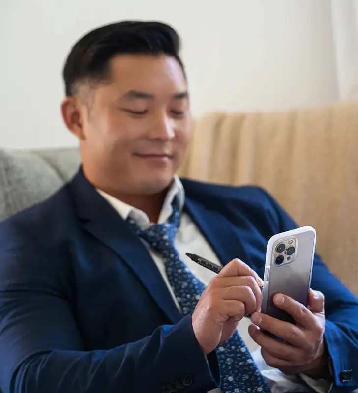 Man using a phone with an ace pro phone case on it.