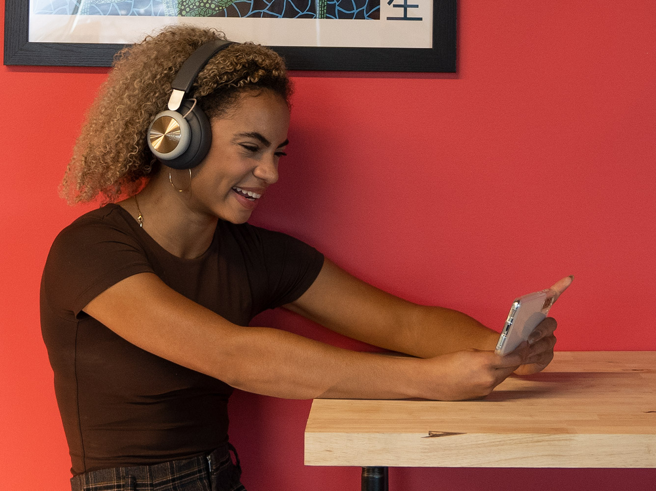 Woman playing video games on her Galaxy S22.