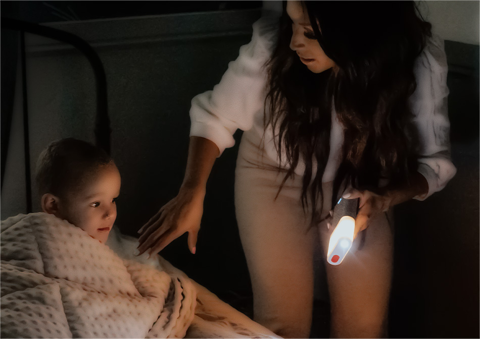 A mother and her child traversing the house at night using the 5-in-1's nightlight feature.